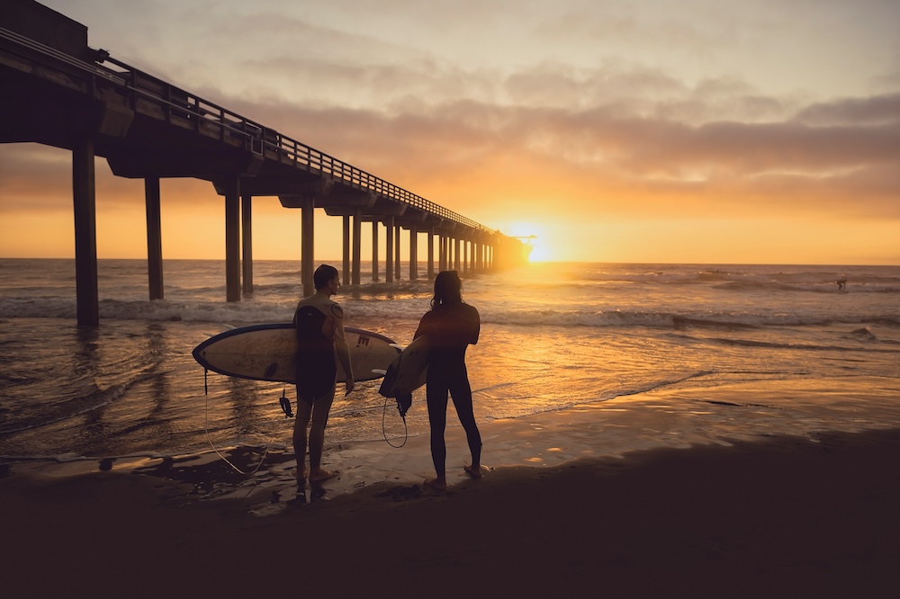 friends watching sunset over the pier