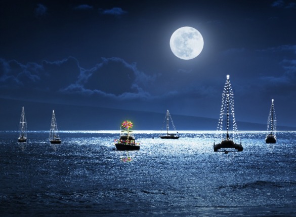 boats decorated with Christmas lights in the ocean | Better Beach Rentals