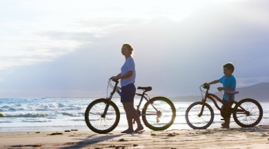 People Riding Bikes on the Beach | Better Beach Rentals